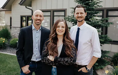 Doctors Coulter, Wheeler and Gilbert smiling together at [[CLIENTEX:PracticeName