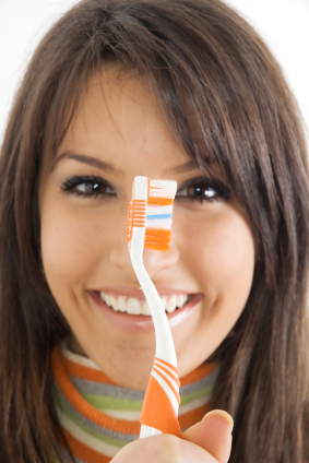 Colorful toothbush held by color matching brunette woman