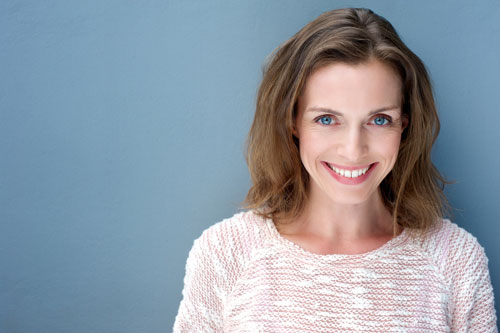 Image of a smiling woman with a chipped tooth at Coulter Family Dentistry.